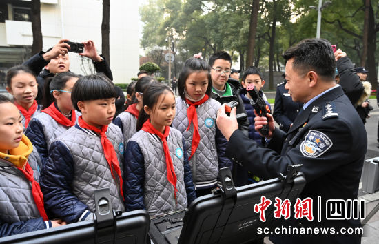 民警向小學生講解警用槍支知識。記者安源攝 民警向小學生講解警用槍支知識。記者安源攝